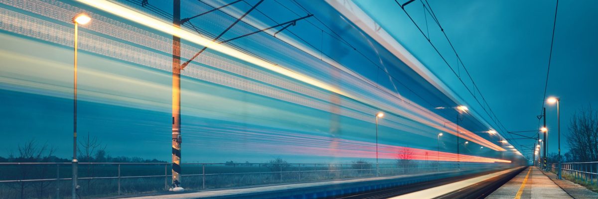 Light trail of the express train in the railway station at the night.