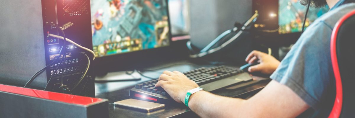 Young streamer gamer playing at e-sports competition - Male guy having fun gaming and streaming online - New technology game trends and entertainment concept - Focus on smartphone