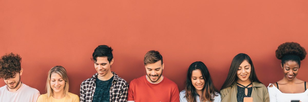 Group young people using mobile smartphone outdoor - Millennial generation having fun with new trends social media apps - Youth technology addicted - Red background