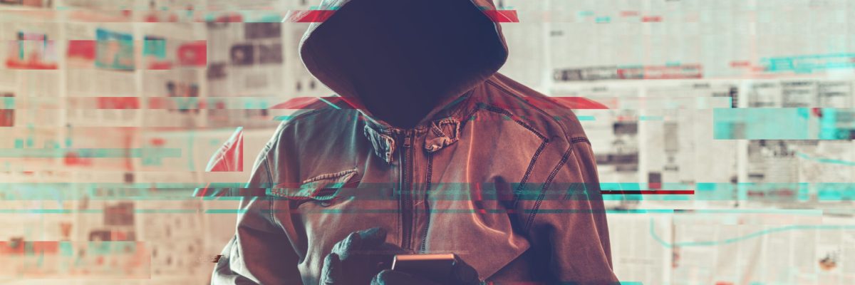 Hooded hacker person using smartphone in infodemic concept with digital glitch effect