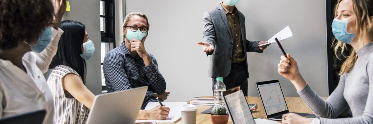 Business people wearing masks in coronavirus meeting, the new normal