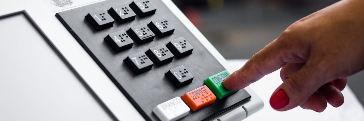 November 16, 2020, Brazil. In this photo illustration a woman simulates a vote in the electronic ballot box used in the elections of Brazil